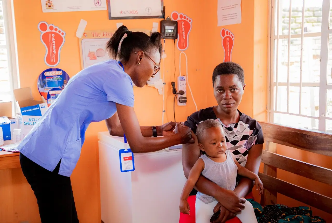 A nurse with a mother and her baby in the clinic