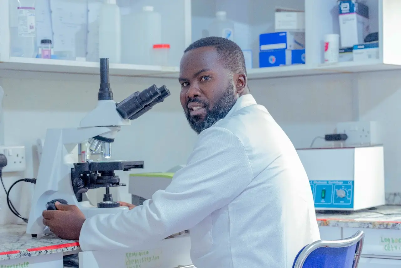A laboratory technician at a microscope