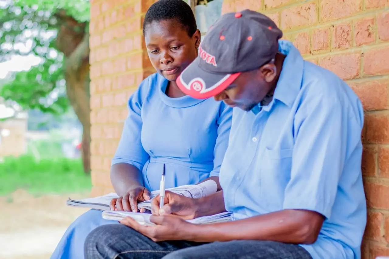 A health surveillance assistant documenting data at a rural outreach clinic