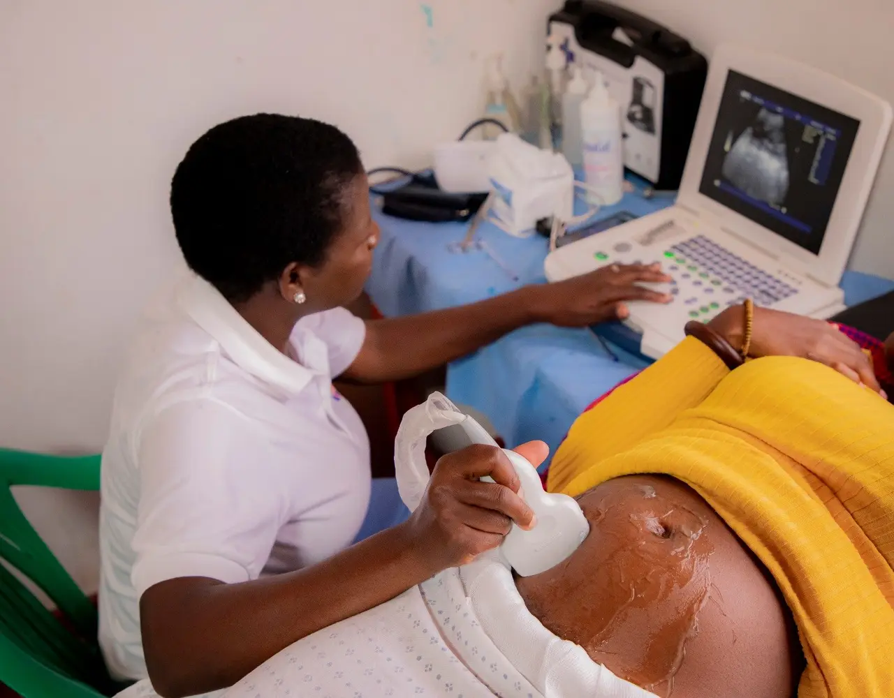 A sonographer performing an ultrasound scan