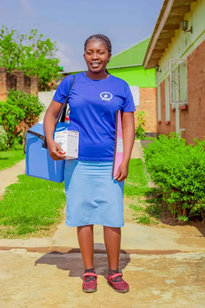 A health worker carrying supplies for deworming and iron distribution